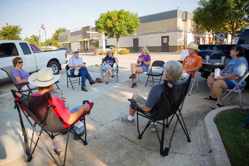 A group of retired friends eat and socialize at the McDonald's parking lot on Aug. 22 in...