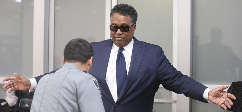 Dwaine Caraway goes through security at the Earle Cabell Federal Building on Commerce Street...