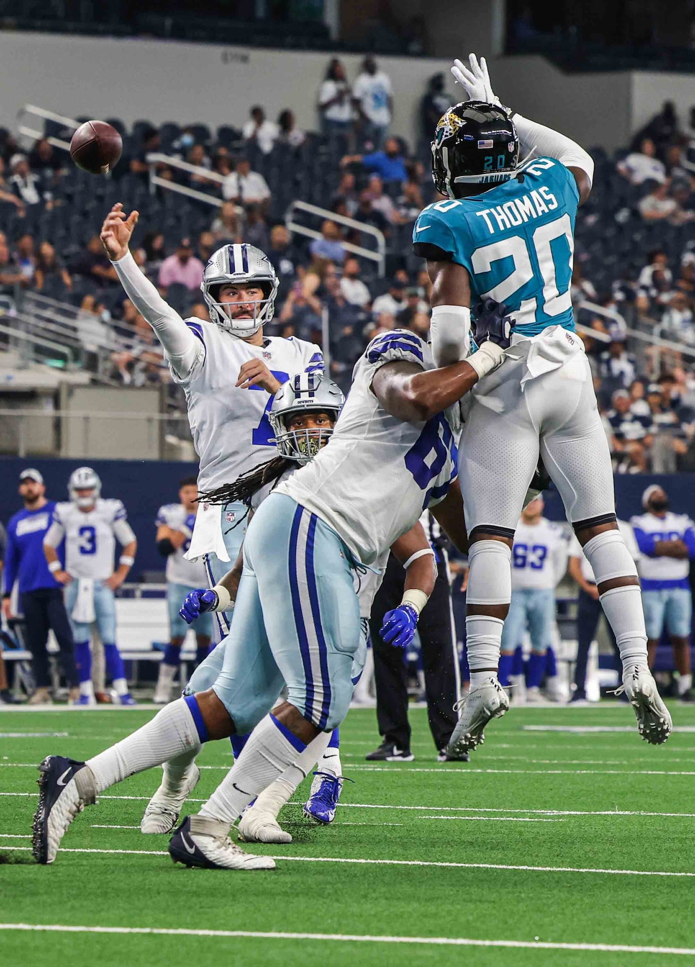 Dallas Cowboys quarterback Ben DiNucci, 7, makes a pass as Jacksonville Jaguars defensive...