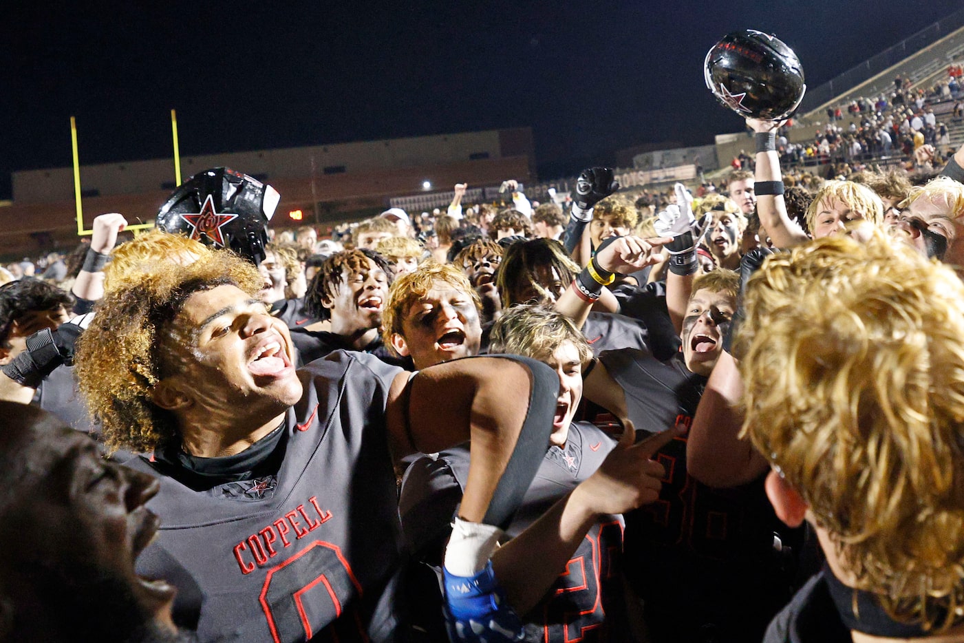 Coppell players celebrate their 35-27 victory against Prosper after a high school football...