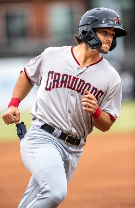 Hickory Crawdad's Josh H. Smith (12) jogs around the bases after hitting a homerun at his...