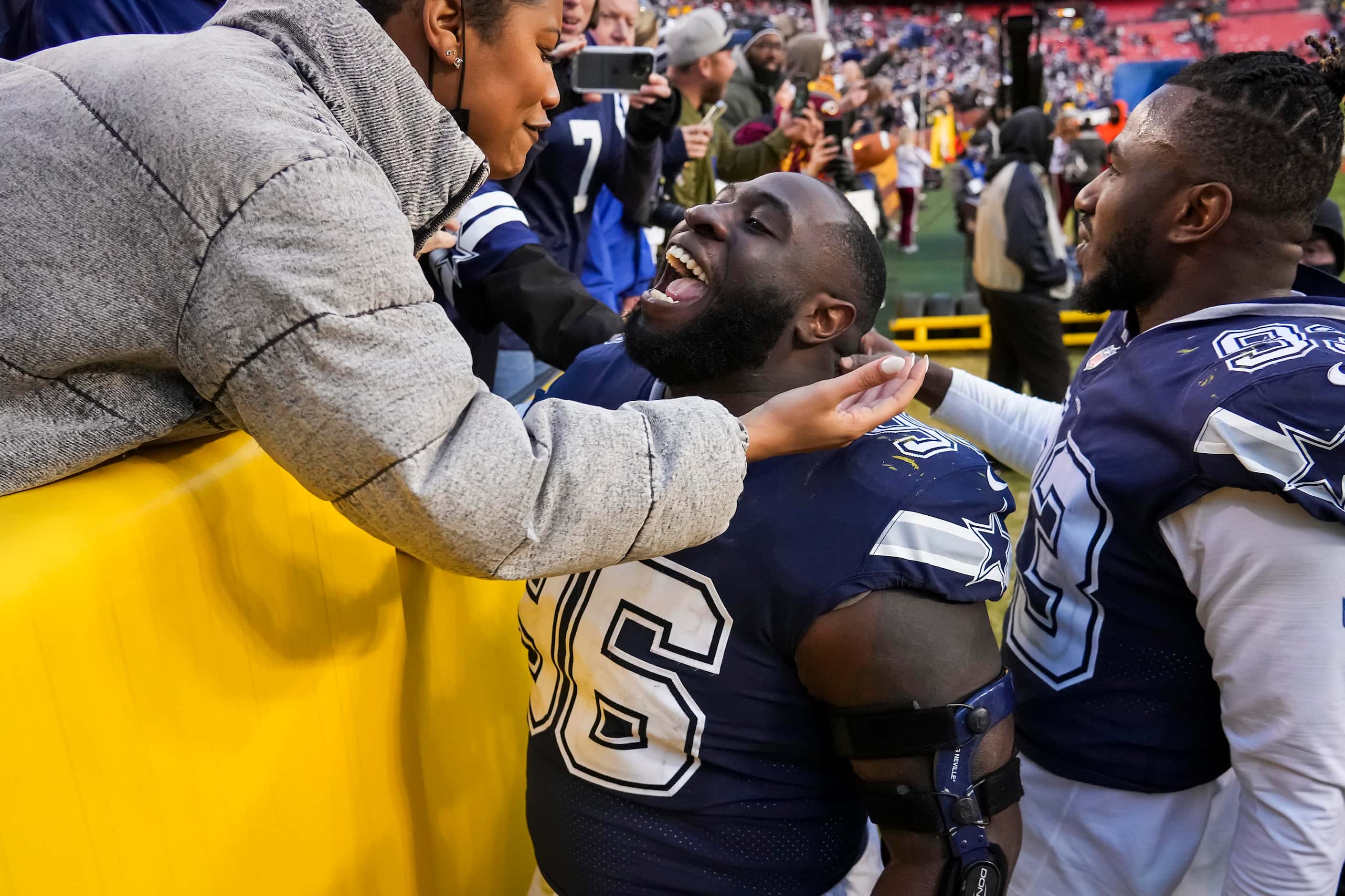 Dallas Cowboys defensive tackle Neville Gallimore celebrates as he leaves the field with...
