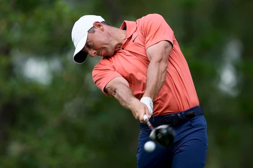 Rory McIlroy, of Northern Ireland, hits his tee shot on the 11th hole during the first round...