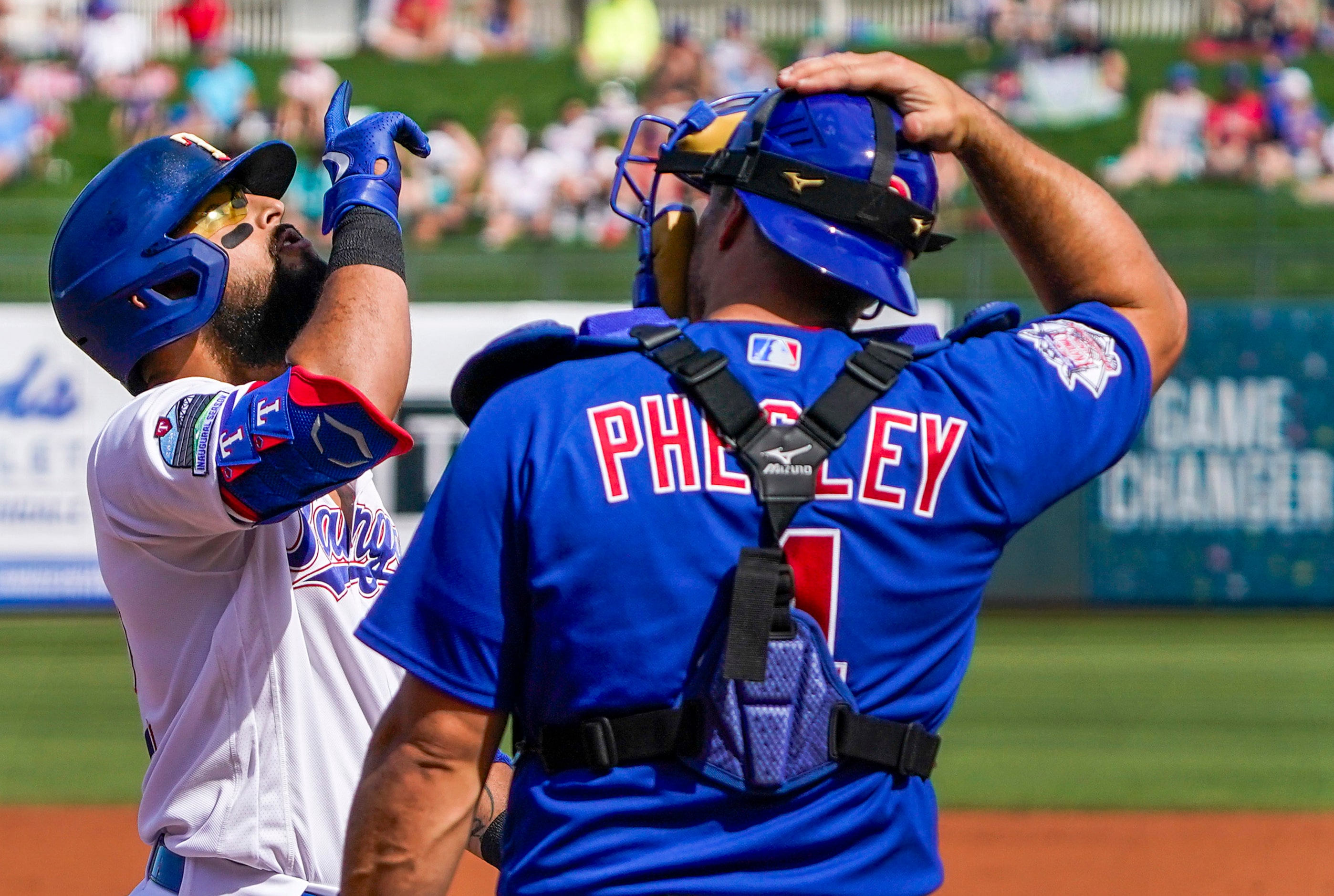 Texas Rangers second baseman Rougned Odor celebrates as he crosses home in front of Chicago...