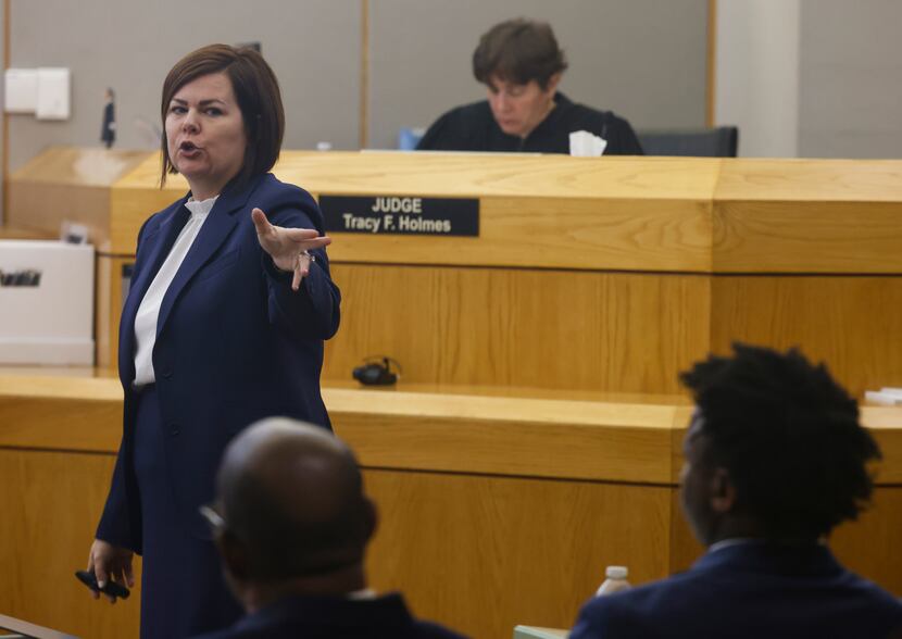 Lead prosecutor Jennifer Falk points towards Darius Fields, right, and his defense attorney...