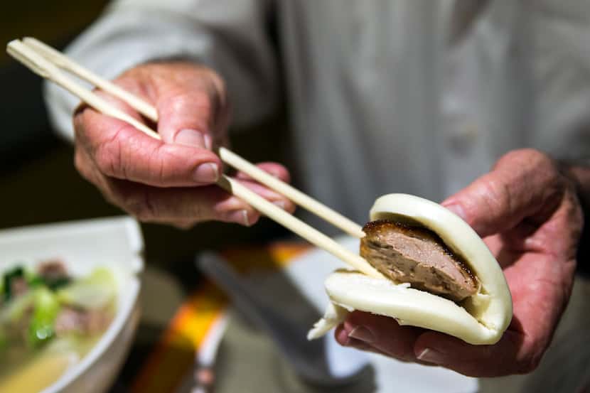 Peking duck is placed in a roll at First Chinese BBQ in Richardson. The Dallas suburb was...
