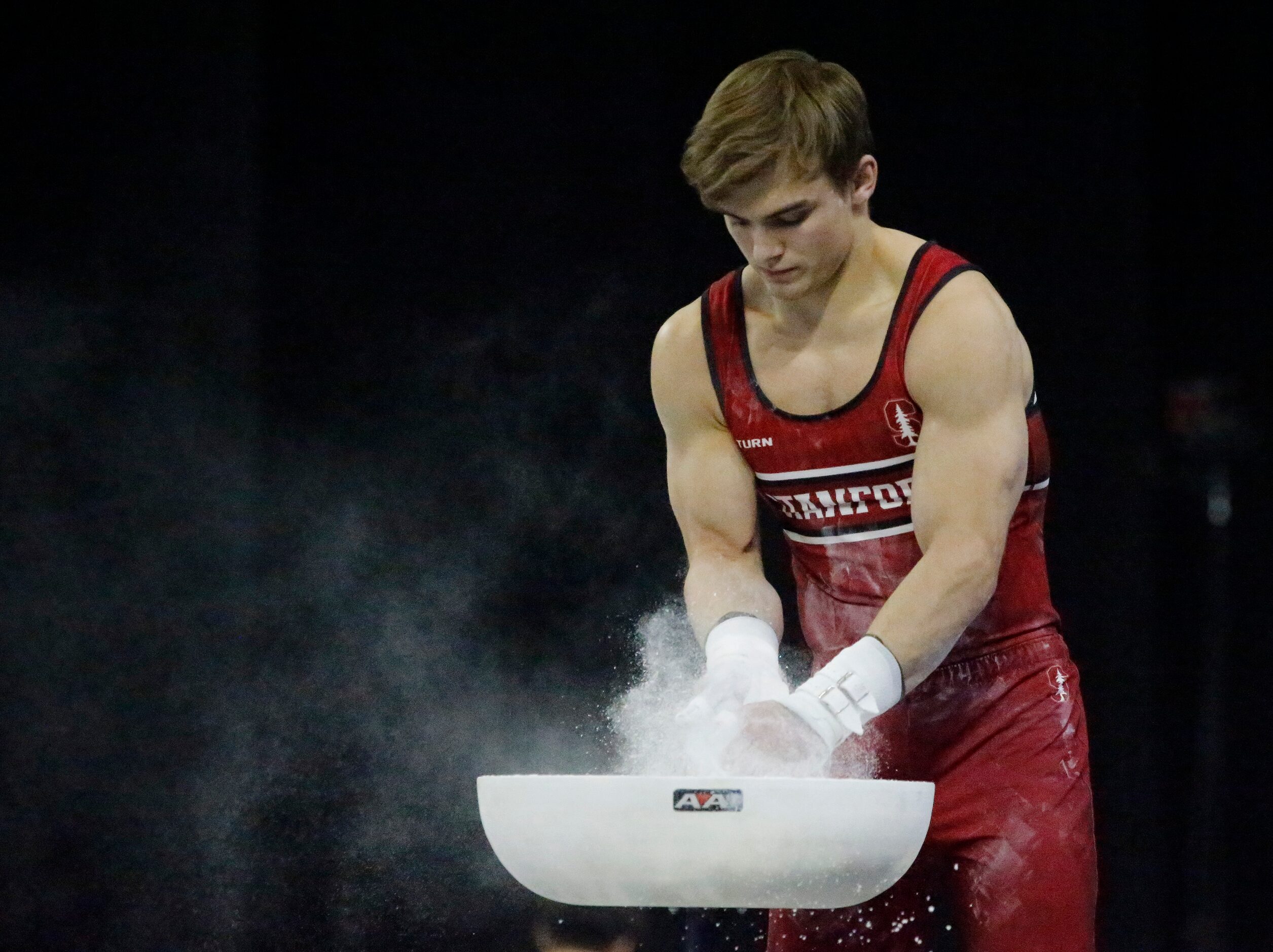 Curran Phillips of Stanford charlks up his hands during the mens finals at the USA...