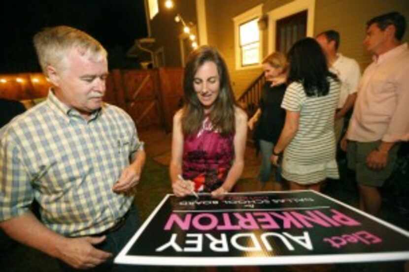  Audrey Pinkerton sign's Peter Kavanagh's election poster during her watch party in Dallas,...