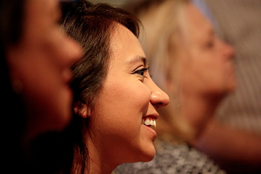 
Ana Van de Venter (center) smiles as she listens to Texas Gov. Greg Abbott at Pecan Lodge...