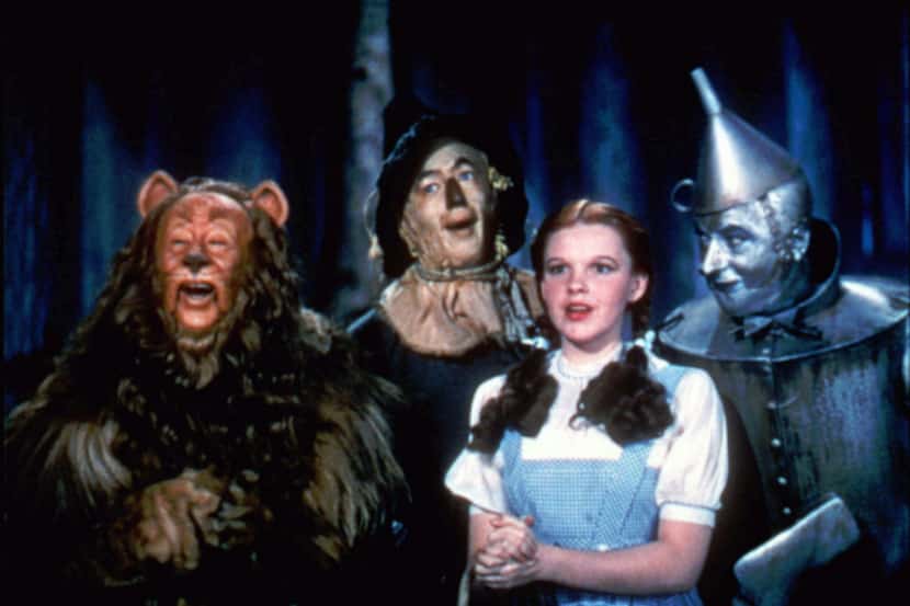 Bert Lahr as the Cowardly Lion, Ray Bolger as the Scarecrow, Judy Garland as Dorothy, and...