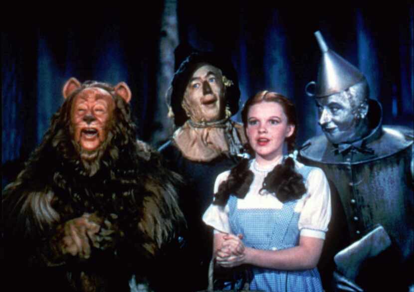 Bert Lahr as the Cowardly Lion, Ray Bolger as the Scarecrow, Judy Garland as Dorothy, and...
