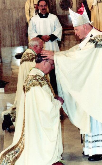 Feb. 11, 2002:
Cardinal Theodore E. McCarrick lays his hands on Bishop Kevin Farrell during...