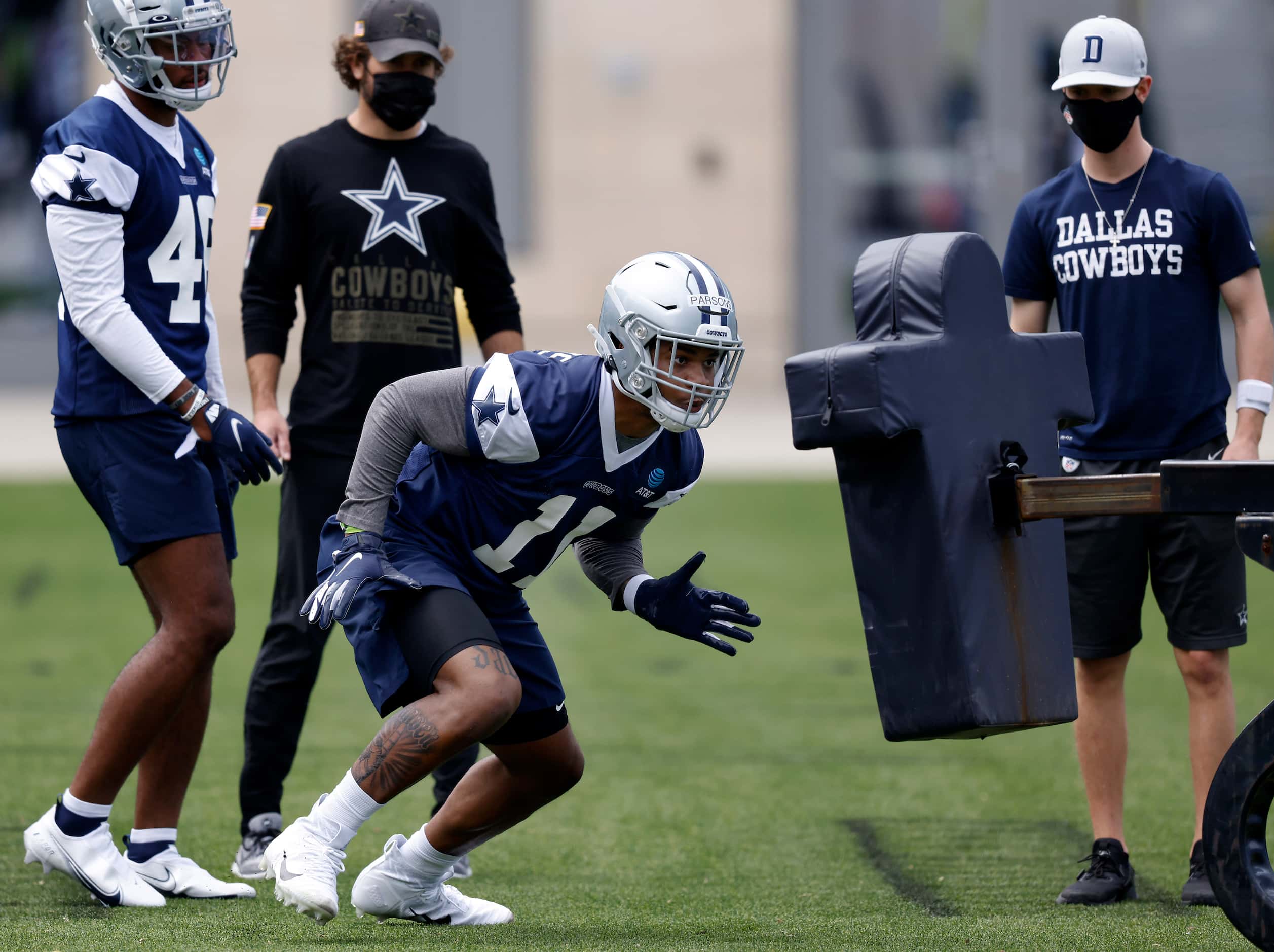 Dallas Cowboys rookie linebacker Micah Parsons (11) hits the sled for the first time since a...