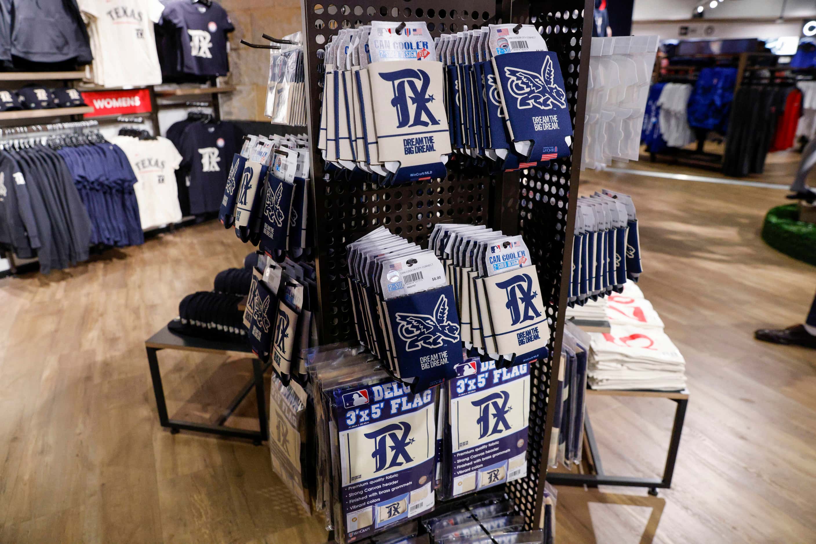 Texas Rangers City Connect flags and can coolers hang on a display for sale at Globe Life...
