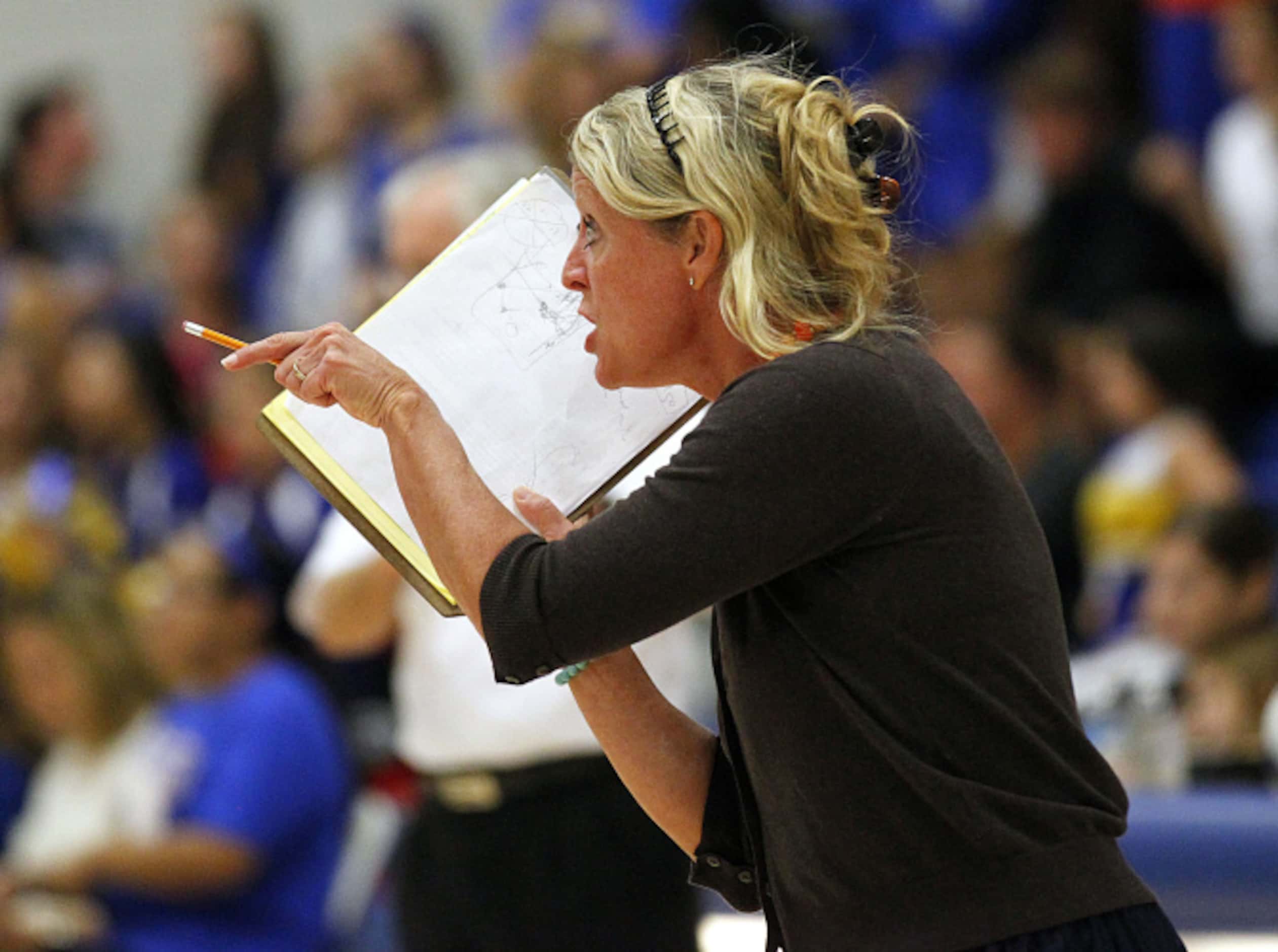 Frisco Centennial volleyball coach Kari Bensend gets on one of her players during their...