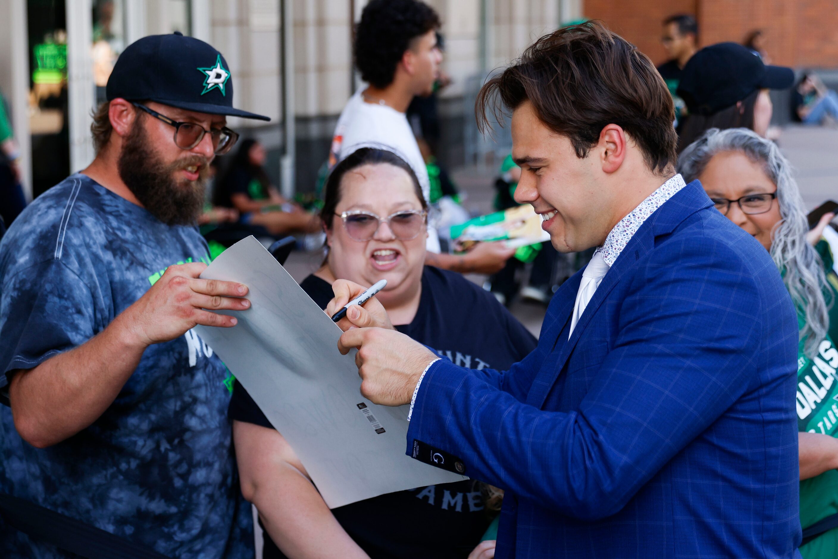 Dallas Stars center Logan Stankoven gives autographs to fans during the team’s home opener...