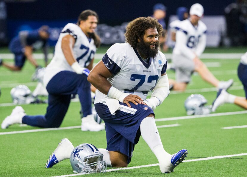 Dallas Cowboys center Joe Looney (73) stretches during a Dallas Cowboys training camp...