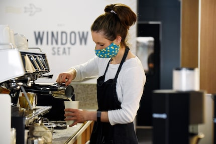 Kristen Boyd prepares drinks for customers at Window Seat coffee shop in Dallas. It opened...