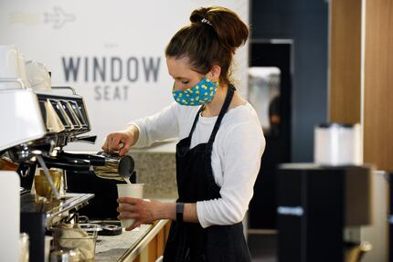 Kristen Boyd prepares drinks for customers at Window Seat coffee shop in Dallas. It opened...