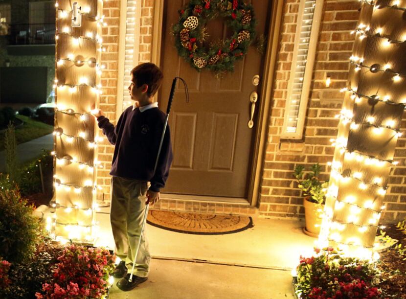 Zach Thibodeaux, 10, stares into the Christmas lights following his orientation and mobility...
