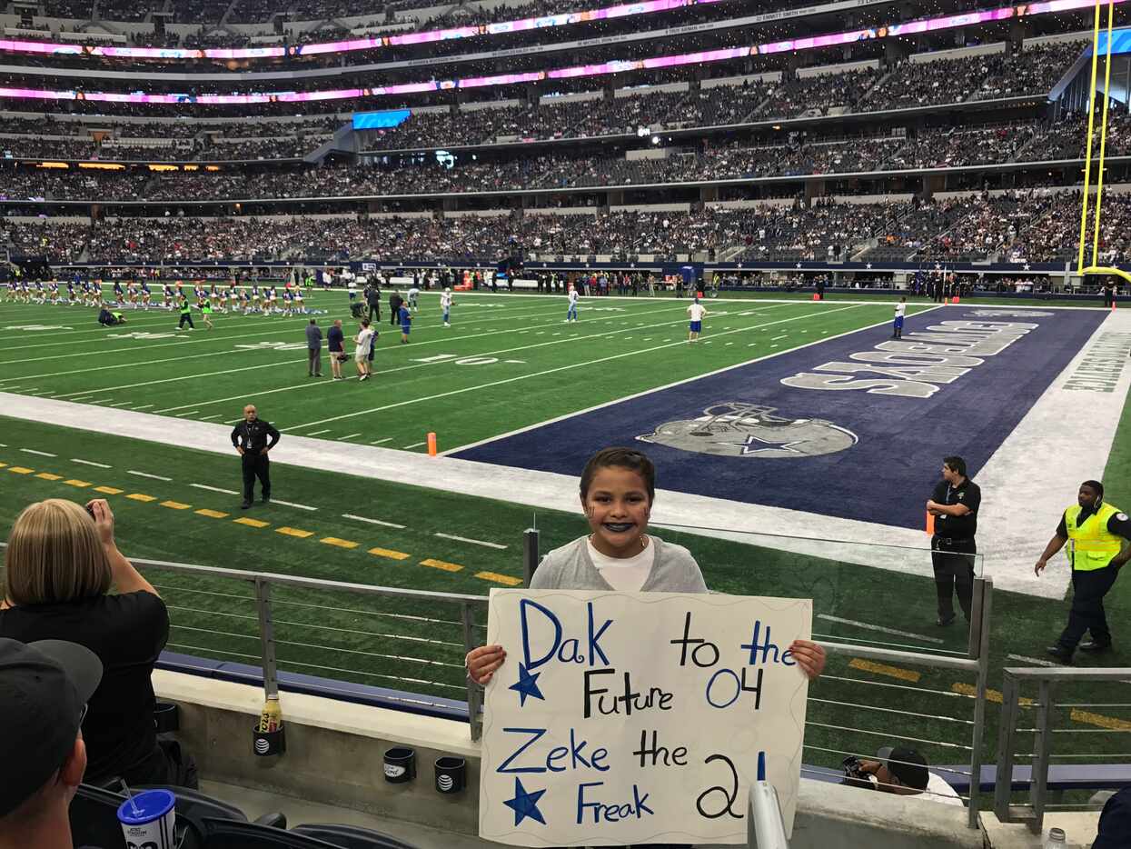 Alyssa Ayala shows off her poster at a Dallas Cowboys game against the Baltimore Ravens in...
