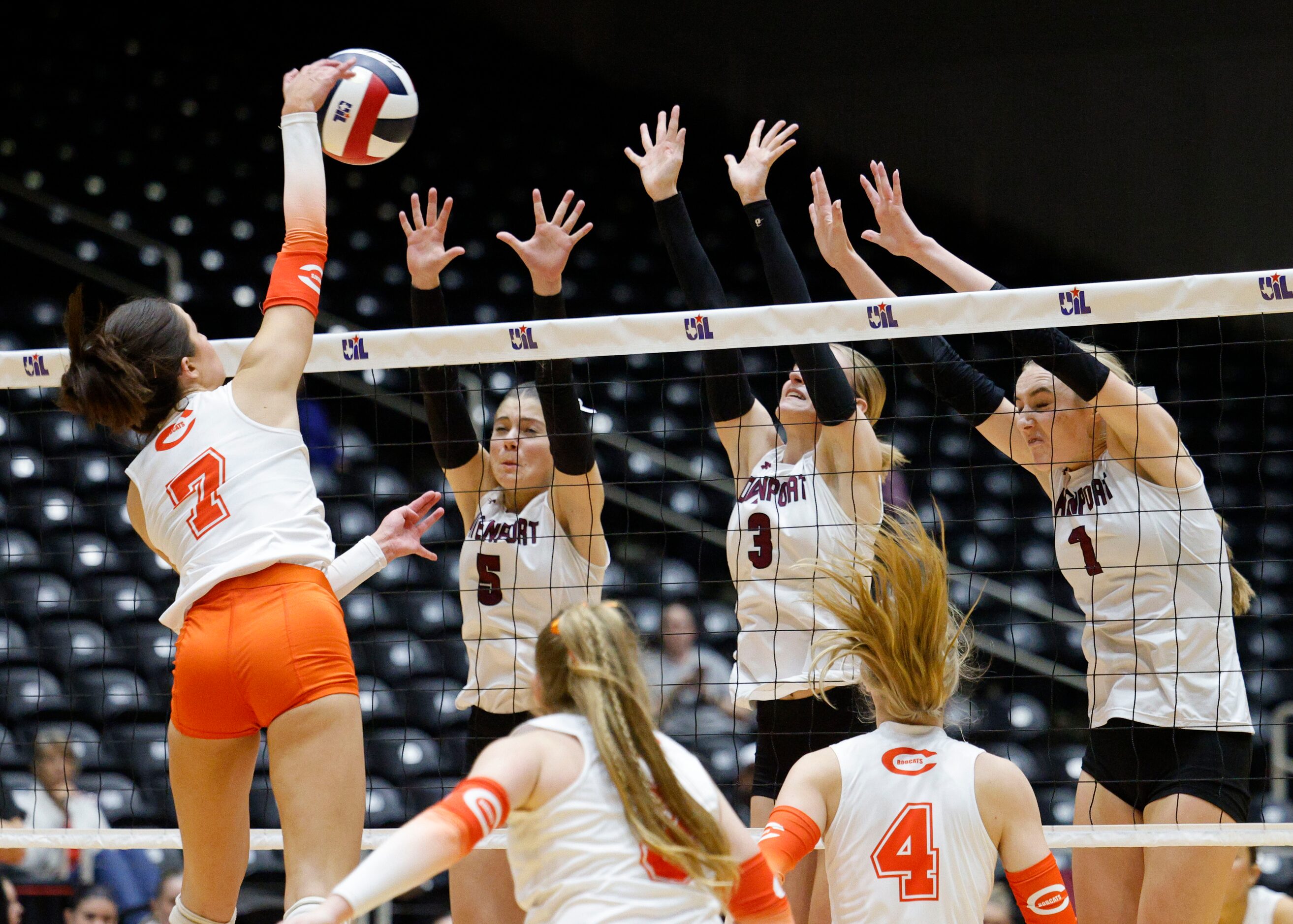 Celina's Ryan McCoy (7) spikes the ball as Comal Davenport's Comal Davenport's Lexi Dahl...