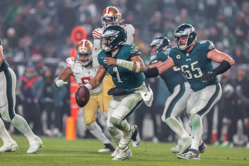 Philadelphia Eagles quarterback Jalen Hurts (1) rolls out against the San Francisco 49ers in...