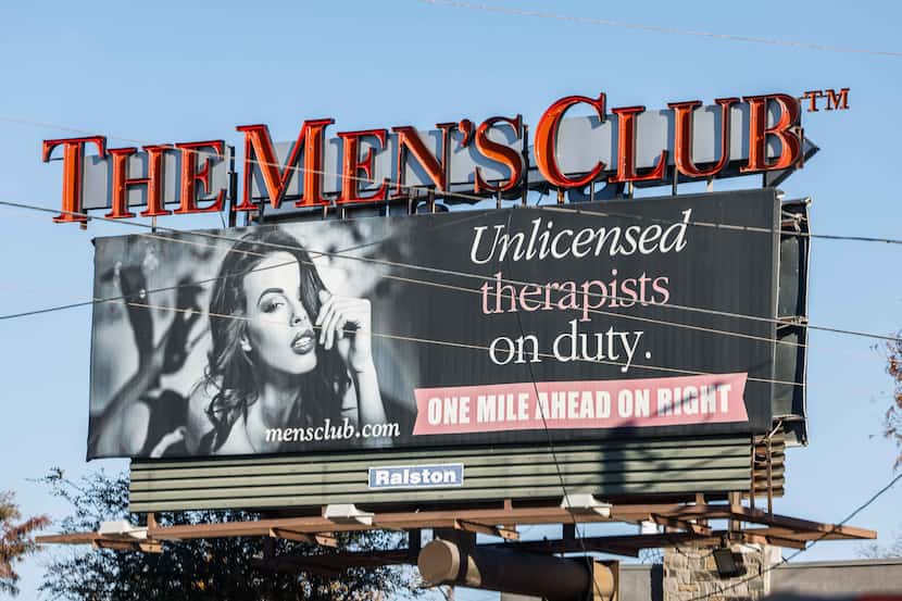 A billboard for The Men's Club of Dallas strip club is displayed on W Northwest Hwy in...
