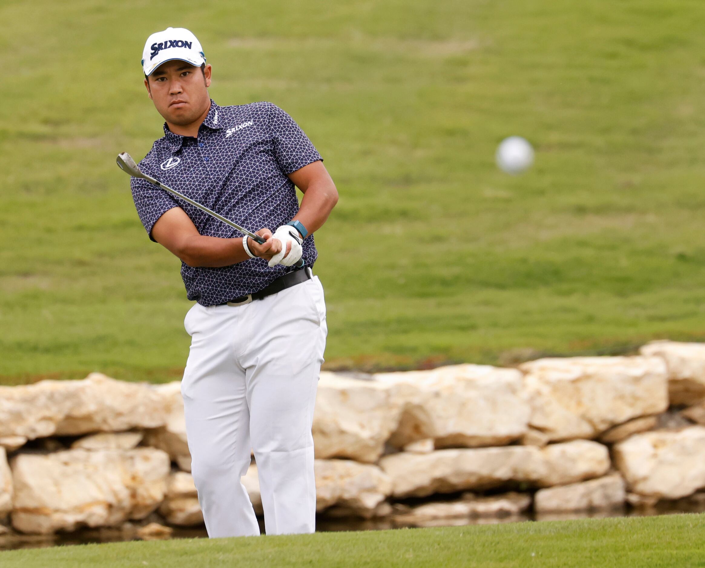 Hideki Matsuyama watches his ball on the green on the 18th hole during round 2 of the AT&T...