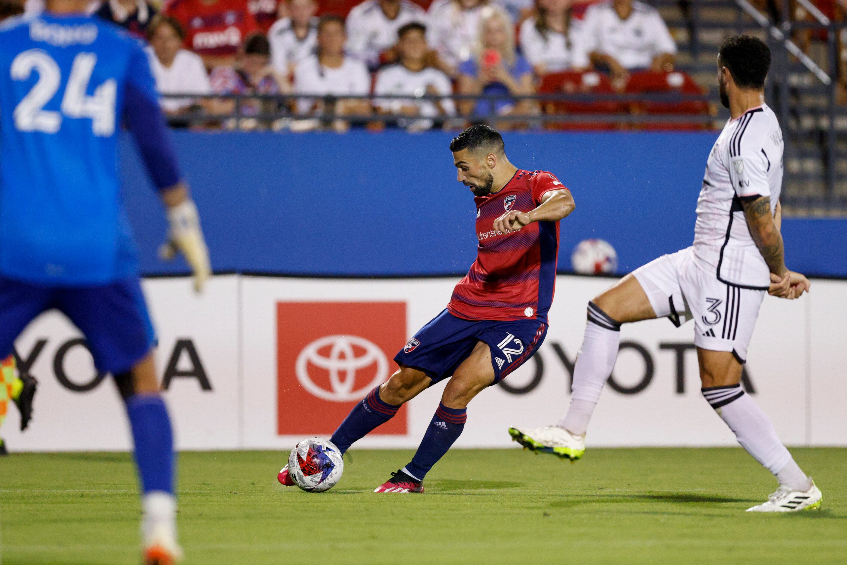 FC Dallas midfielder Sebastian Lletget (12) crosses the ball ahead of D.C. United defender...