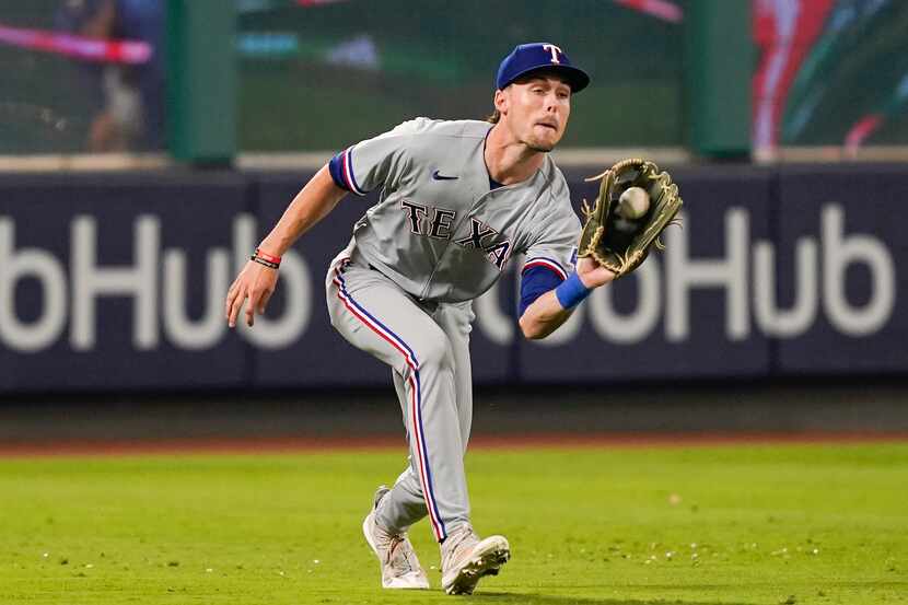 Texas Rangers center fielder Evan Carter catches a line ball hit by Los Angeles Angels' Zach...