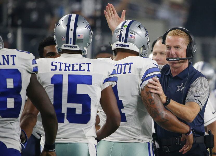 Dallas Cowboys quarterback Dak Prescott (4) celebrates with head coach Jason Garrett after...