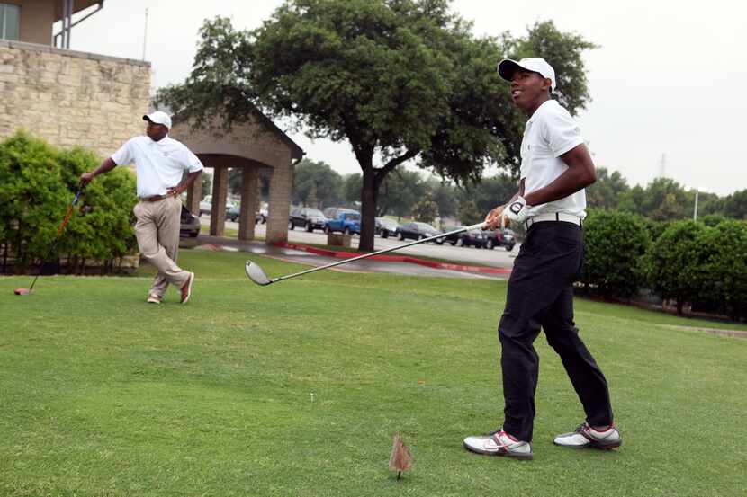 Cedar Crest golf pro Ira McGraw and his son Lester Bell, right, tee off during some practice...