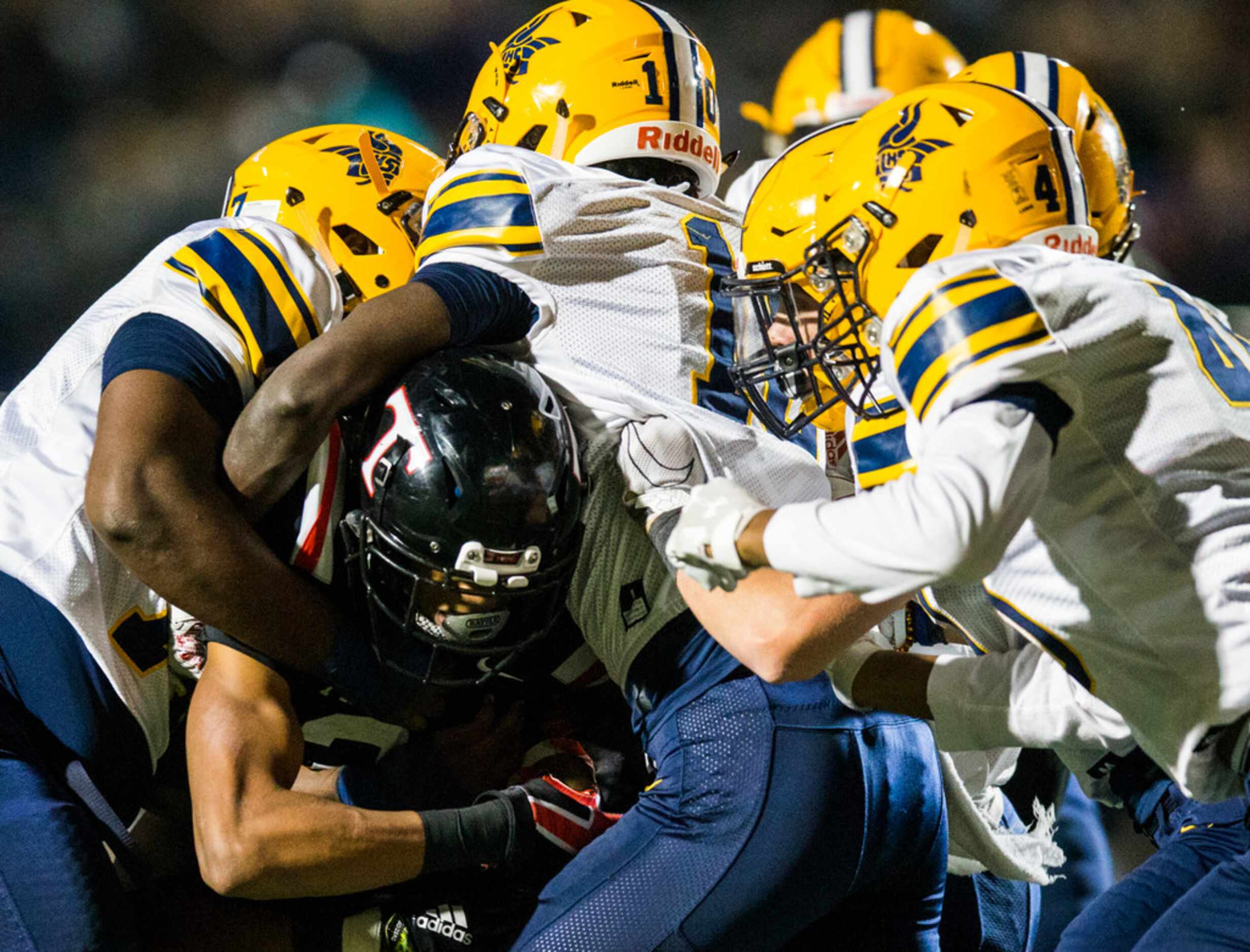 Euless Trinity runningback Ollie Gordon (2) is tackled by Arlington Lamar defenders during...