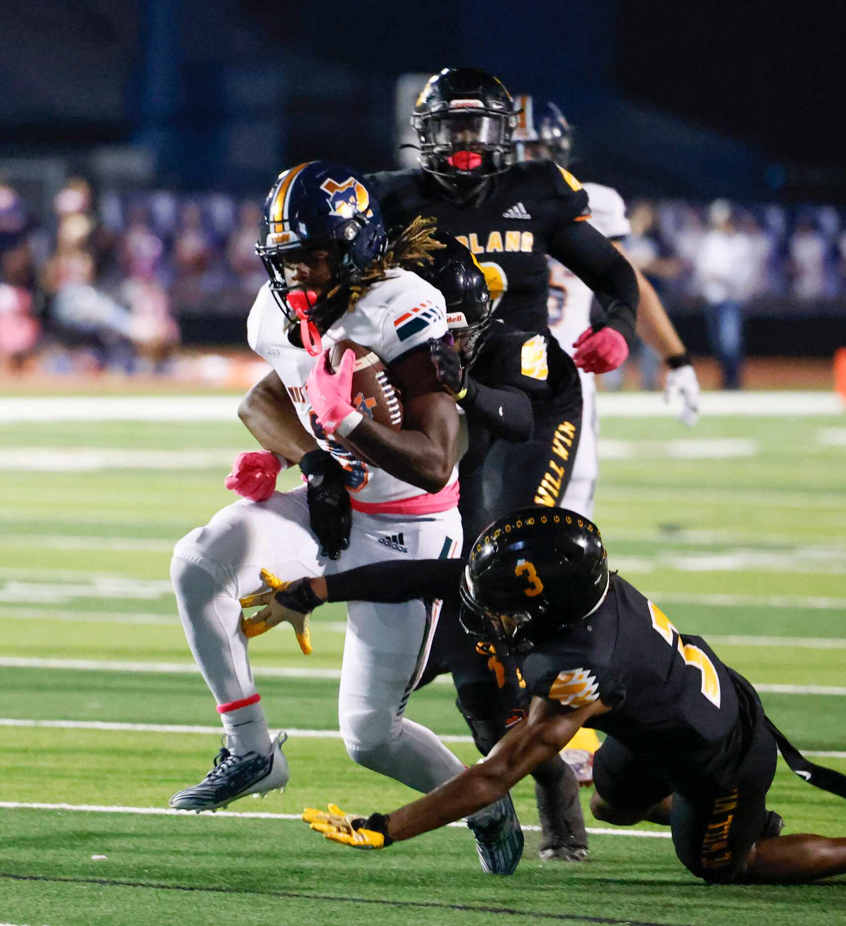 Sachse High School Josh Ridge (center) is tacked by Garland high school’s O’Shea Johnson...