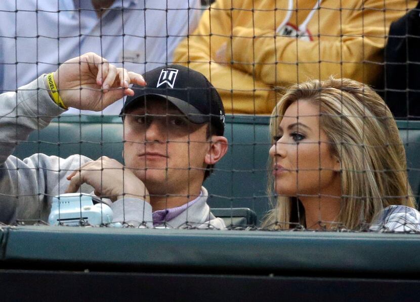 In this April 14, 2015, file photo, Cleveland Browns quarterback Johnny Manziel, left, sits...