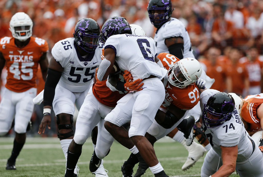 AUSTIN, TX - SEPTEMBER 22:  Darius Anderson #6 of the TCU Horned Frogs is tackled by Chris...
