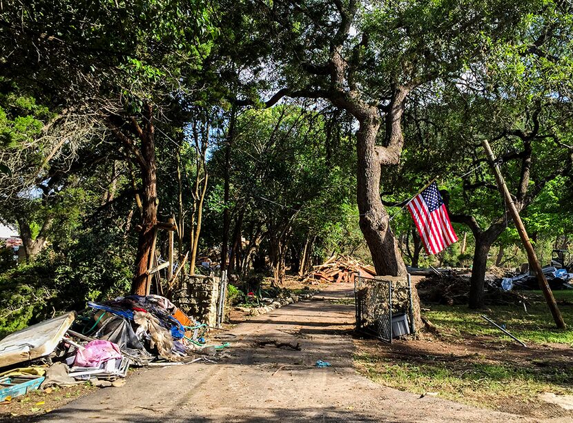  The driveway of a home that was demolished on Rim Road near the Blanco River on Wednesday,...