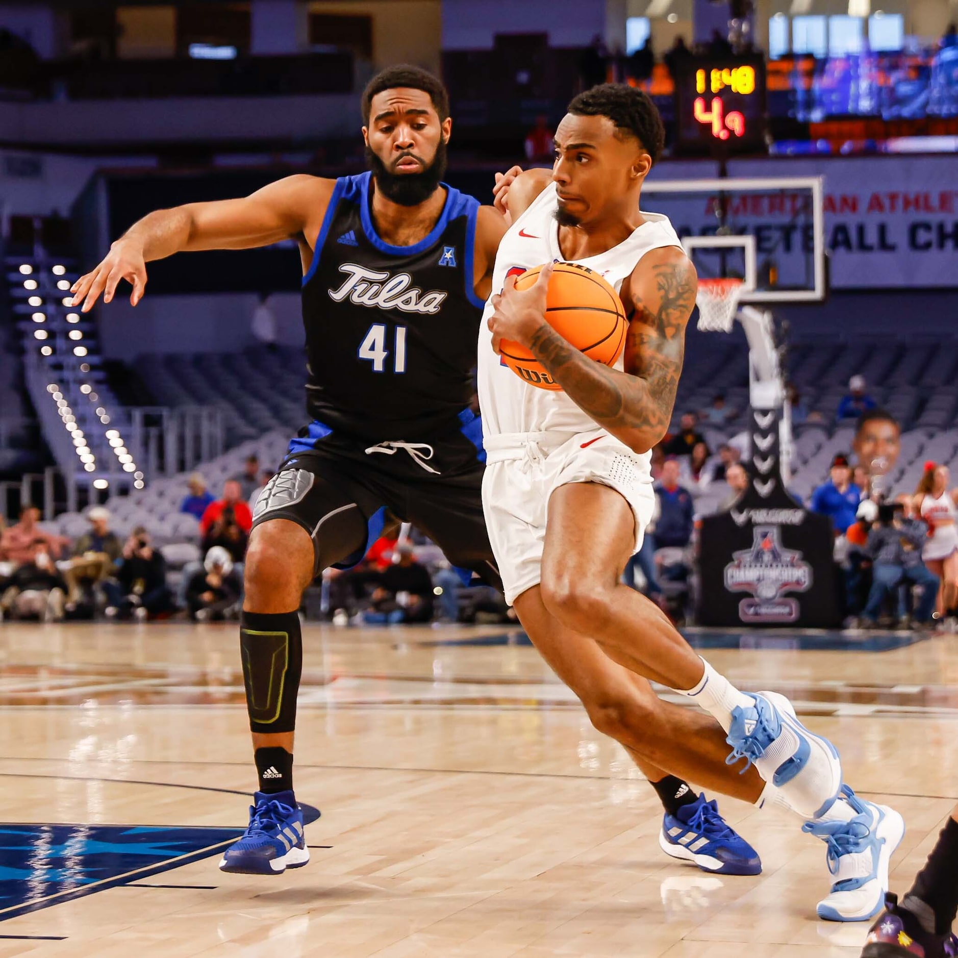 Southern Methodist Mustangs guard Michael Weathers (23) goes around Tulsa Golden Hurricane...