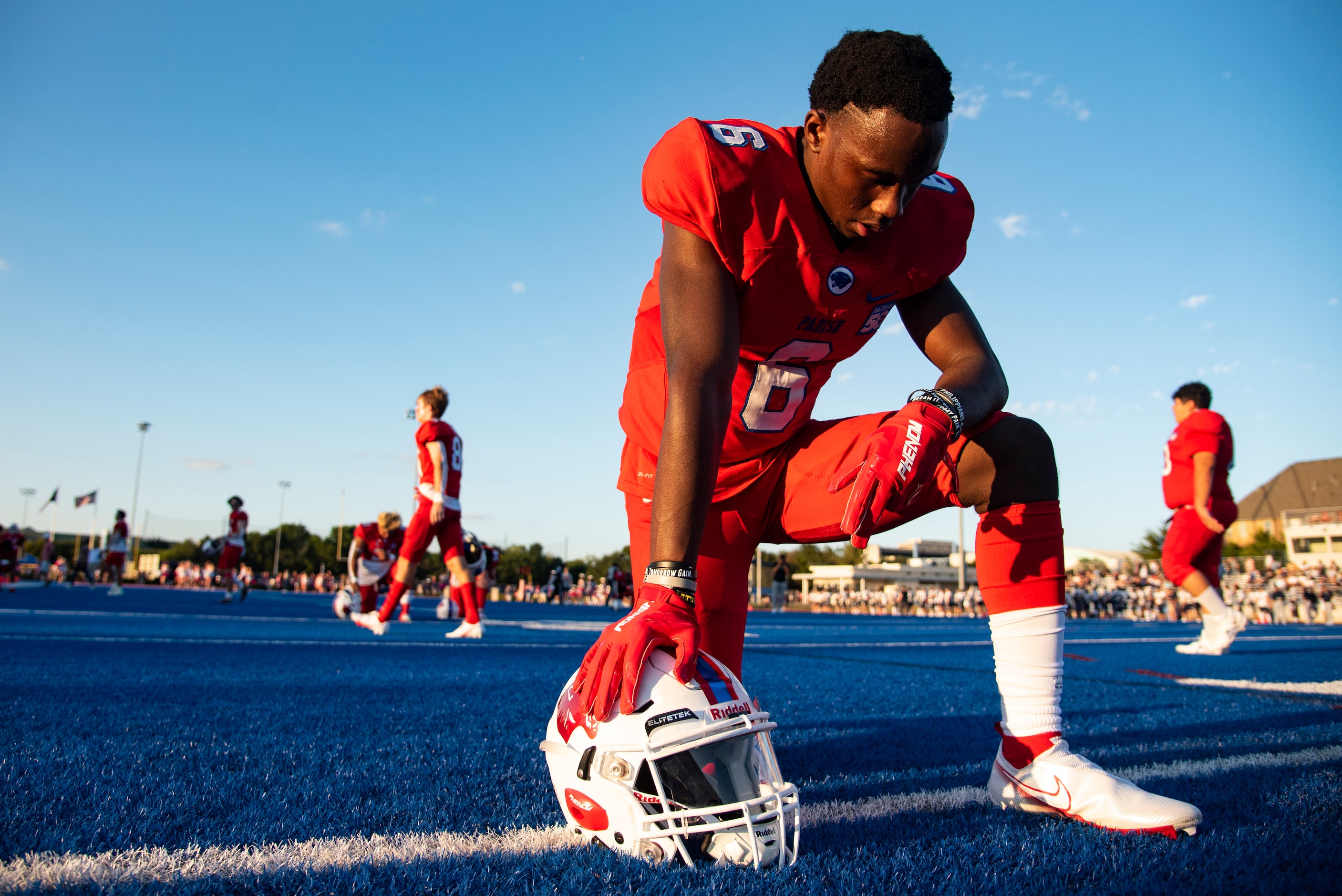 Parish Episcopal junior Bryson Blackmore (6) bows his head in prayer after taking the field...