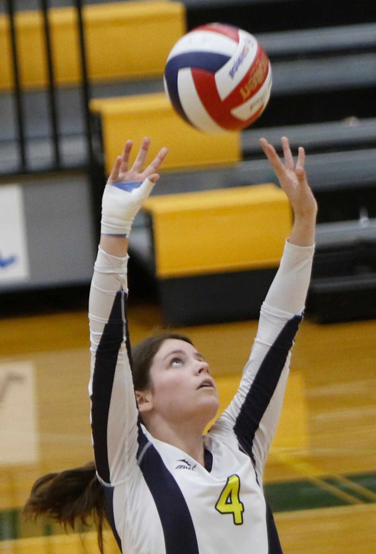 Highland Park setter Jeanne Tulimieri (4) seta a teammate during the first game of their...
