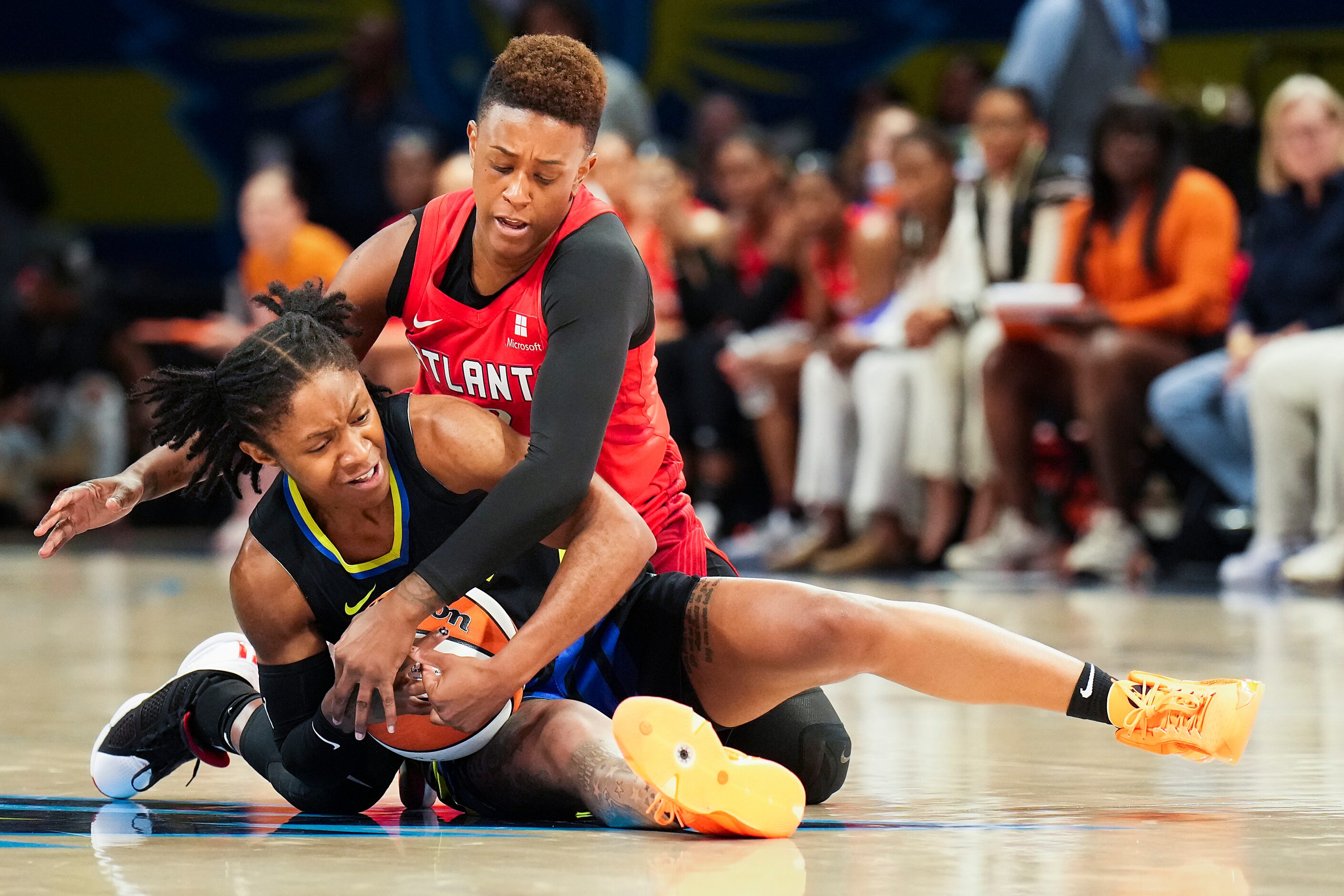 Dallas Wings guard Crystal Dangerfield (11) fights for a loose ball against Atlanta Dream...