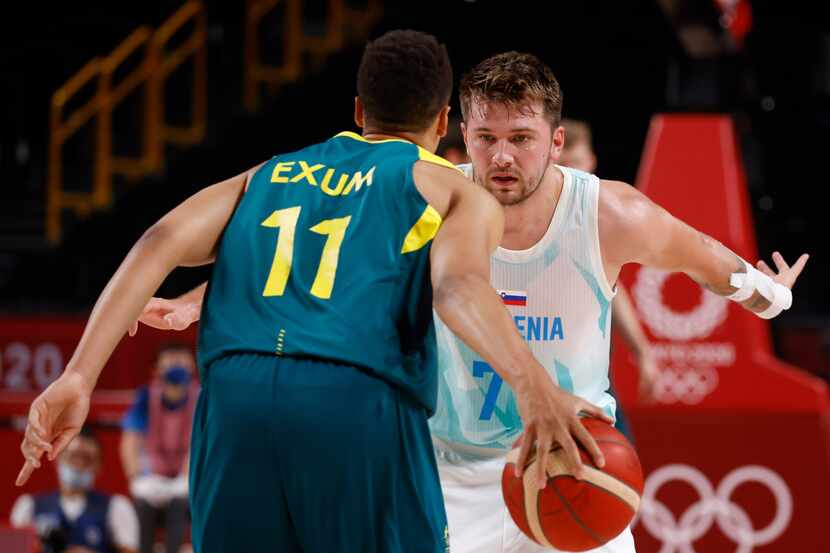 Slovenia’s Luka Doncic (77) looks to defend as Australia’s Dante Exum brings the ball up the...