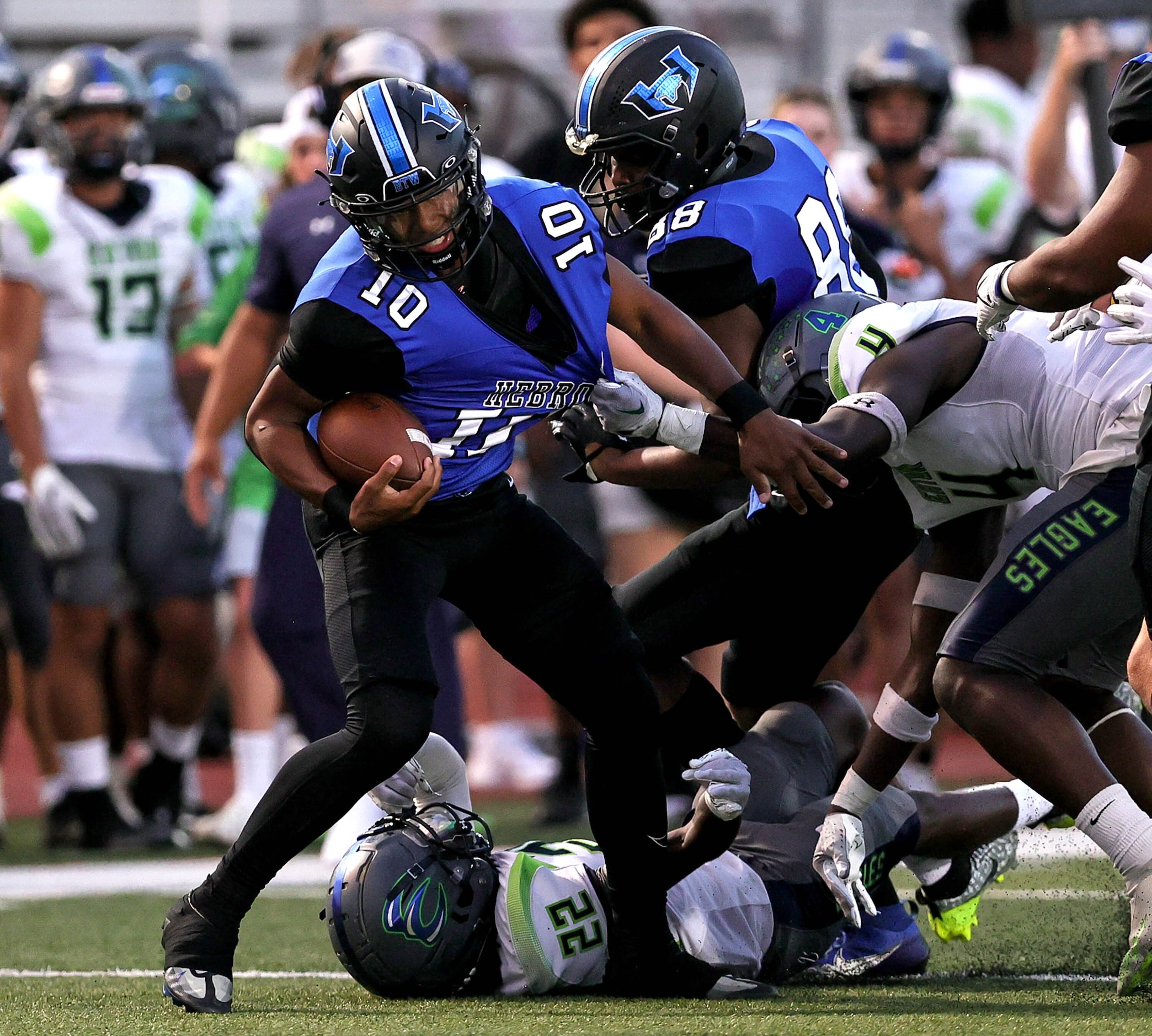 Hebron quarterback Patrick Crayton Jr (10) tries to break free from Eaton safety Fred Moore...