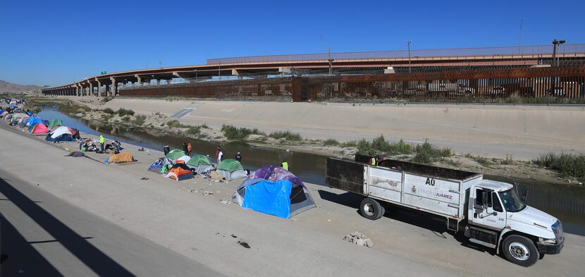 Municipal sanitation workers clear out part of “Little Venezuela” along the banks of the Rio...