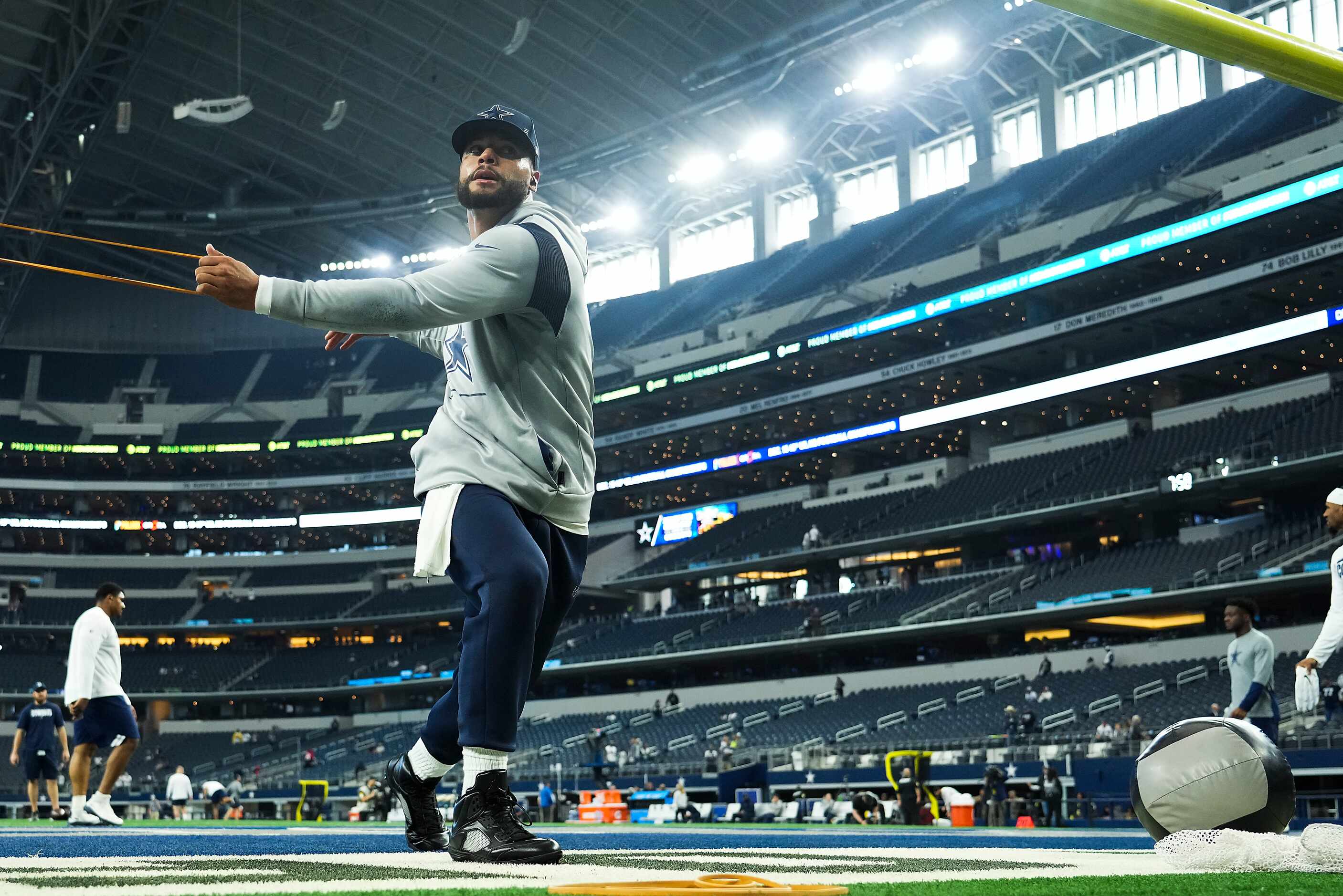 Dallas Cowboys quarterback Dak Prescott stretches before an NFL football game against the...