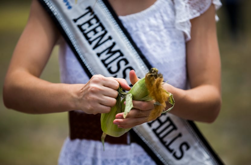 Copperas Cove's Miss Teen Five Hills, Carleigh Ross, 17, participates in a corn shucking...