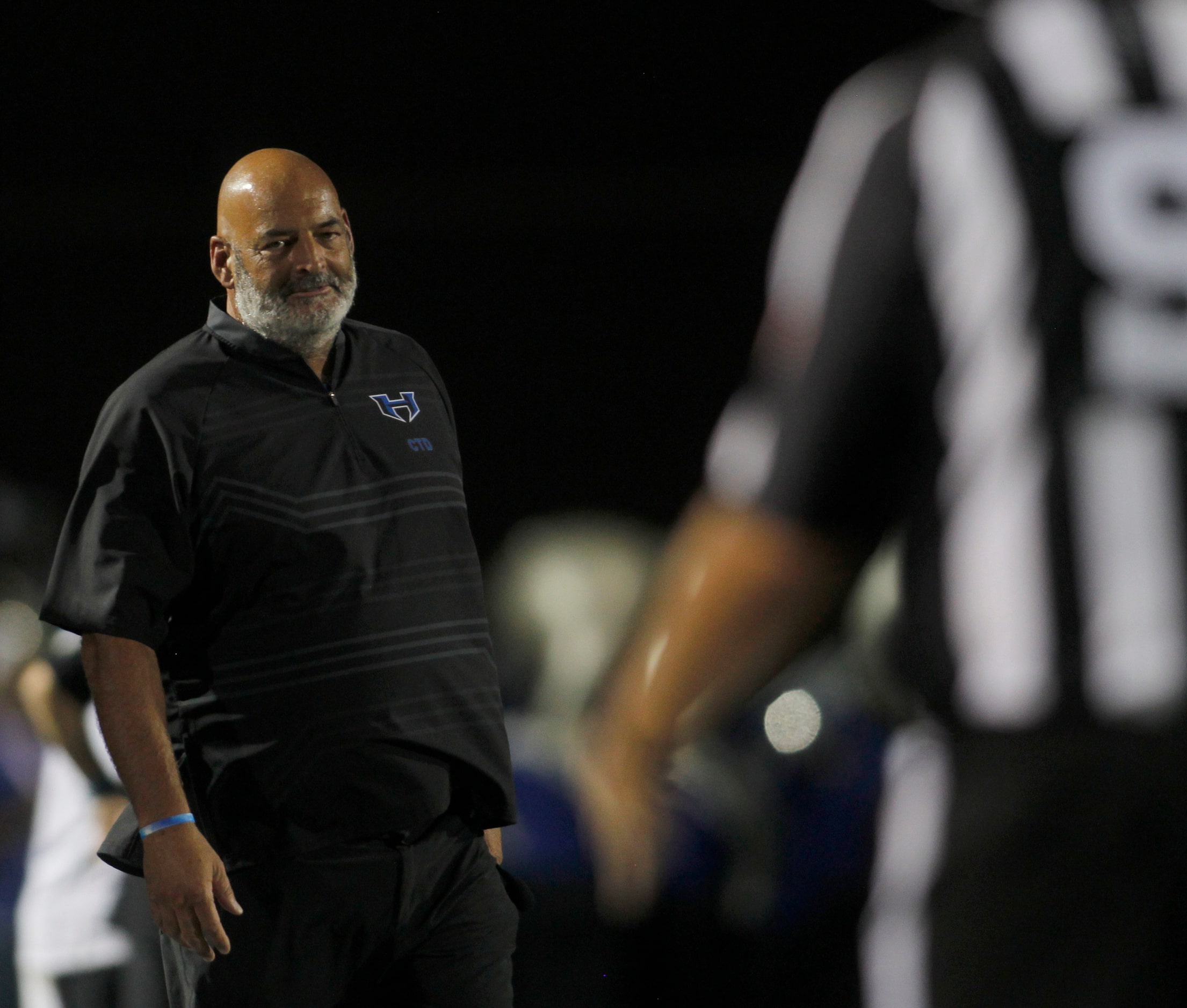 Hebron head coach Brian Brazil glances toward a game official following a call during first...