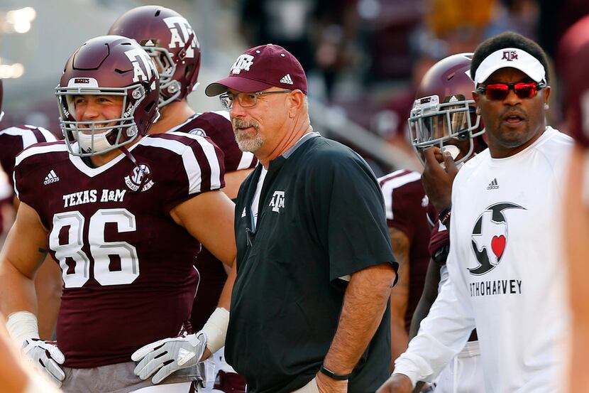 Texas A&M Aggies offensive coordinator Noel Mazzone watches his players warm up before...
