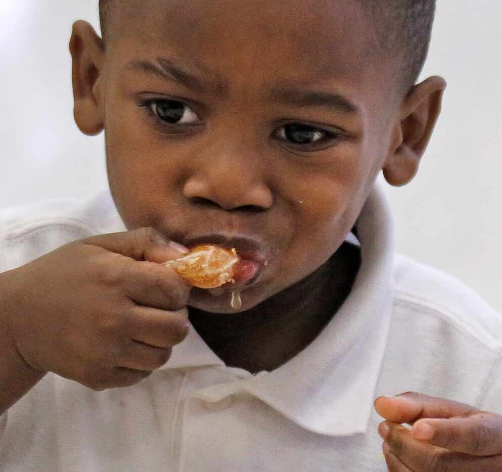 Pre-K student D'Anthony Harris samples a Satsuma orange at N.W. Harllee Early Childhood...